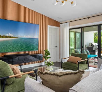 Modern Feature Wall.  Wood paneling and a large TV create a sleek focal point.