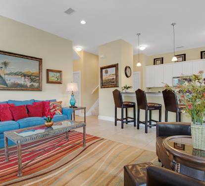 Bright and cheery living room has queen sofa sleeper for additional guest