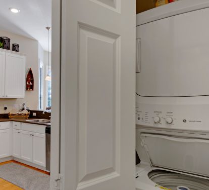 stackable washer and dryer are located on the first floor just off the kitchen