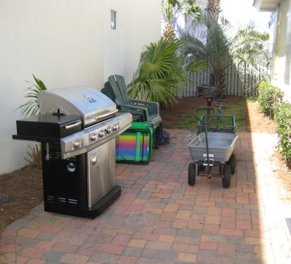 Gas grill, two beach wagons for ice chests and toys. Picnic table -- not shown