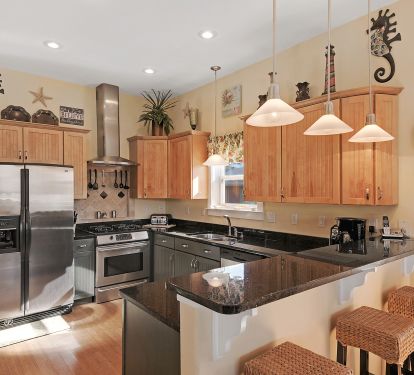 Beautiful custom kitchen w/ granite counters, stainless appliances and gas stove