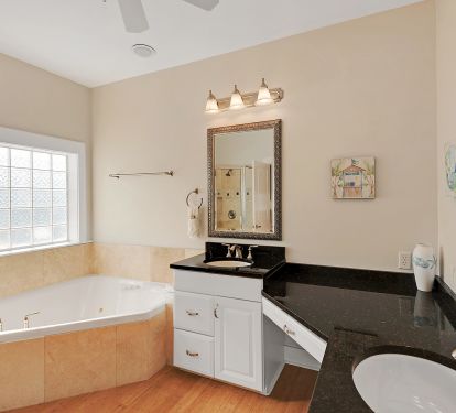 attached bath to master bedroom has jetted tub and separate shower