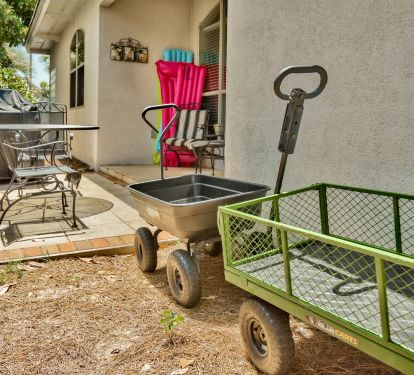 Outdoor patio with furniture, cart included for carrying items to the beach