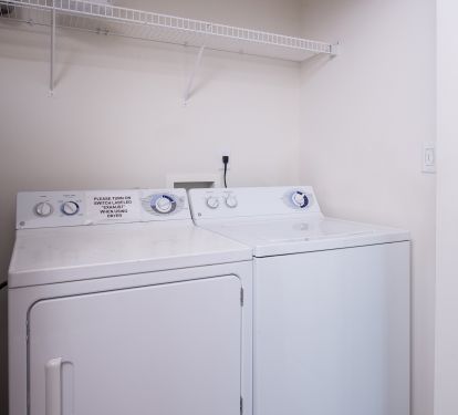 Full Size Washer and Dryer.  Ironing Board and Iron.