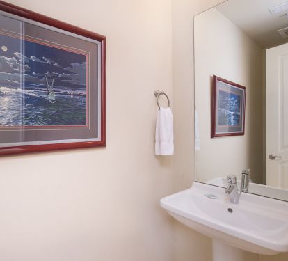 Convenient half bath located between the living area and hall bedrooms