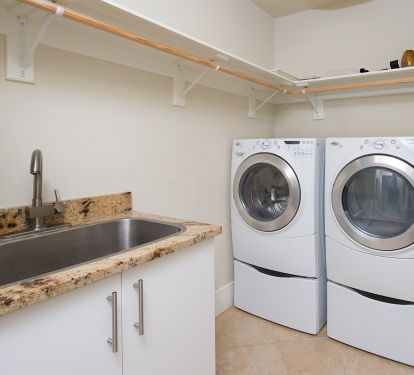 Full service laundry room complete with sink for washing off leftover sand!
