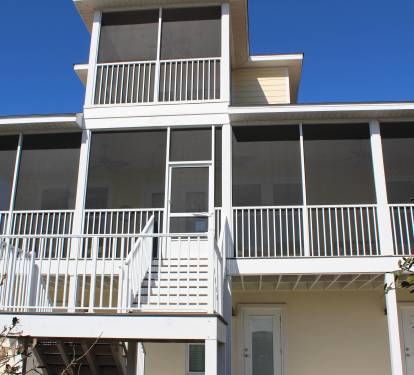 Beach side of house showing screened porches which offer amazing gulf views