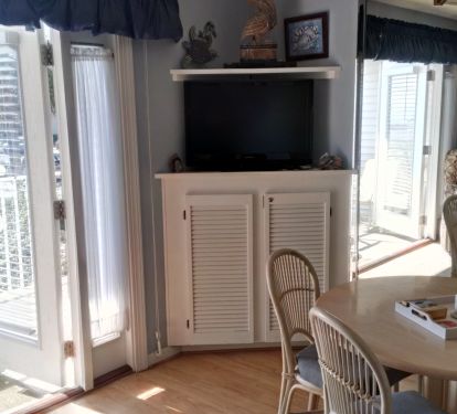 French doors open to a view of the Gulf and the hot tub/pool area.