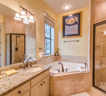Master Bathroom with granite double sink vanity, jaccuzzi tub, glass enclosed tile shower with body jets