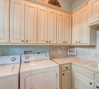 Large laundry room off of kitchen and door to outdoor shower station