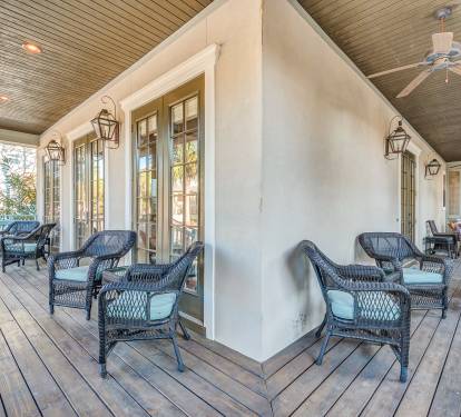 Large covered wrap around first floor porches with plenty of seating, old world gas lantern sconces, ceiling fans, gas grill, 4 bikes, beach toys, beach chairs