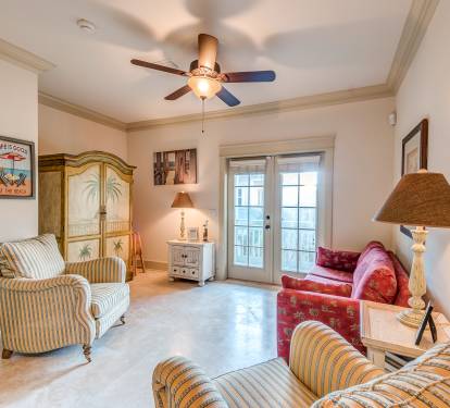 Carriage House Living Room with glass french doors to private balcony, ceiling fan, TV/DVD, pull out queen sofa