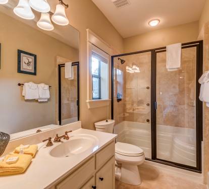 Carriage House Bathroom with glass enclosed tile shower with body jets