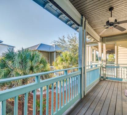 Carriage House private balcony with ceiling fan and adirondack chairs