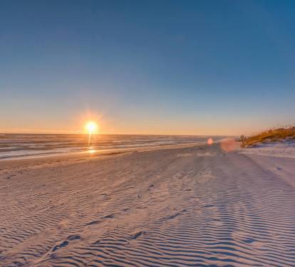 The pristine white sand beaches of the Emerald Coast with breath taking sunsets