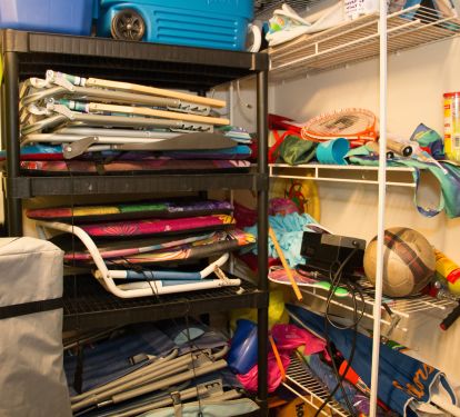 Ground floor storage closet with beach chairs, cooler, umbrella, toys and more