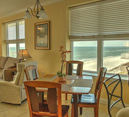 Dining and living areas showing the corner unit's windows
