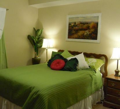 The second bedroom features a queen sized bed and direct access  to the hall bathroom