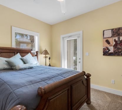 first floor guest bedroom w/ queen bed and access to guest bath