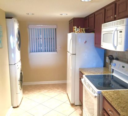 Full Size LG Stack Washer and Dryer. Lots of Custom Storage Cabinets.