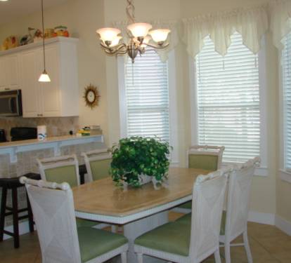 Dining table seats 6 with 3 additional seats at breakfast bar