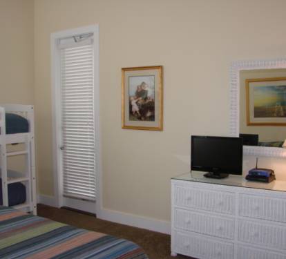 first floor guest bedroom features attached bath and flat screen tv
