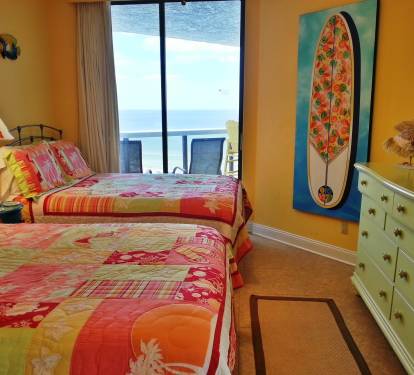 Guest Bedroom 2 full beds , flatscreen TV, DVD player, celing fan, closet, Balcony access.