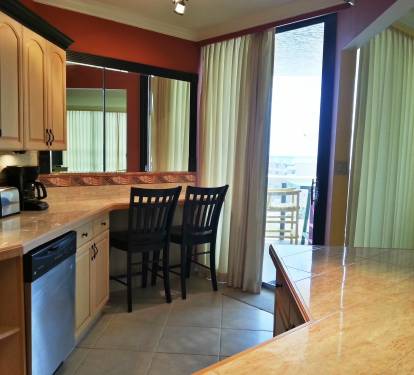 Large kitchen with top of the line appliances. Snack bar in the kitchen with 2 chairs.  Also a snack bar with seating for 6 in the kitchen. Balcony access.
