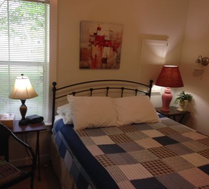 Queen bed with spare linens
