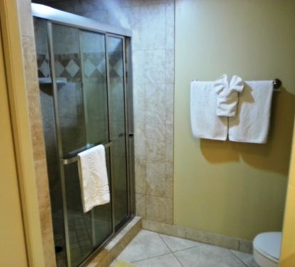 Master Bathroom with a large walk-in shower stone walls  All Linens are supplied. Washer/Dryer also for your use.