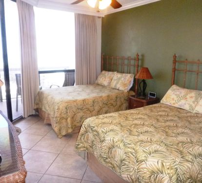 Guest Bedroom 2 full beds , flatscreen TV, DVD player, celing fan, closet, Balcony access.