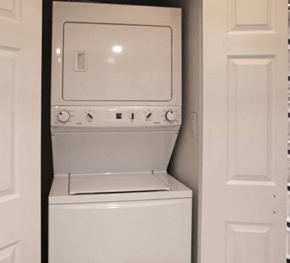 Full size washer/dryer combo in master bathroom. 