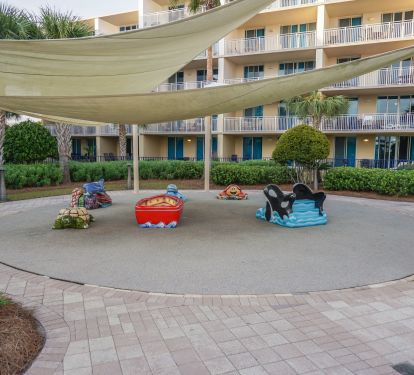 Rubber mat play area that is shaded. 