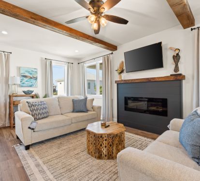 Living Room Features Cozy Electric Fireplace and Large Television