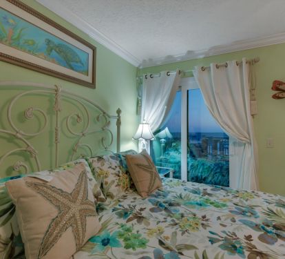 Master bedroom, having sliding glass doors opening to wrap-around balcony