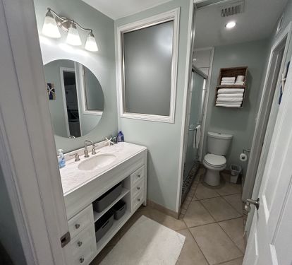 Refreshed bathroom with nice walk-in shower and quality linens