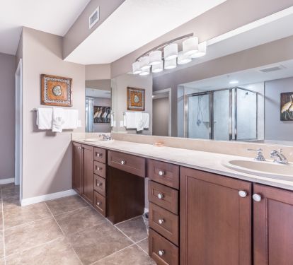 Double sinks and makeup area in master bath. Attached closet and toilet room.