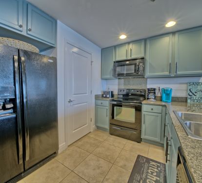 Freshly painted kitchen with pantry and side by side refrigerator!