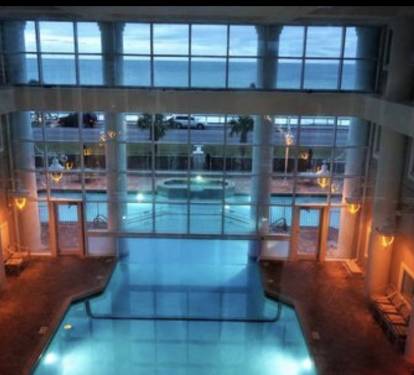 Indoor heated pool that flows outside is beautiful at dusk
