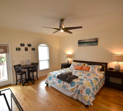 Bedroom 1 Master Suite with King bed bistro table and balcony access