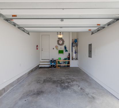 One car garage with beach chairs, utility cart, etc