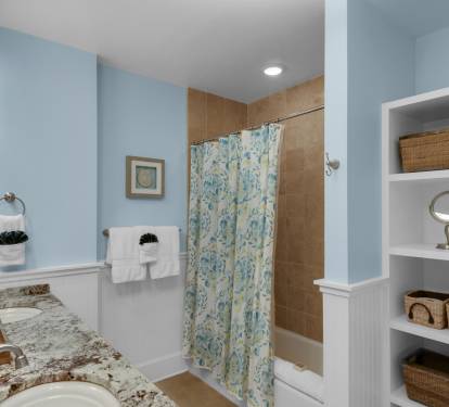 Second Master bath with double sinks and tub/shower combo.