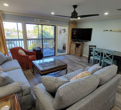 Large living room leads out to expansive screened in deck