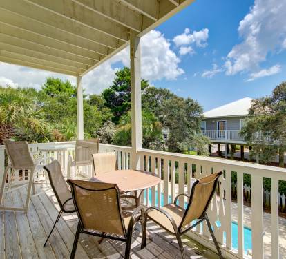 There are two covered balconies with tables and chairs 