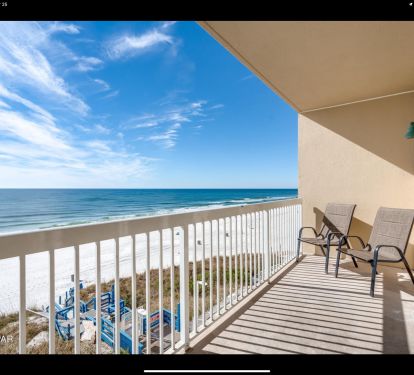 Private beachfront balcony with seating and sweeping views of turquoise Gulf waters