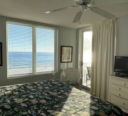 Master bedroom with king bed and private access to balcony.