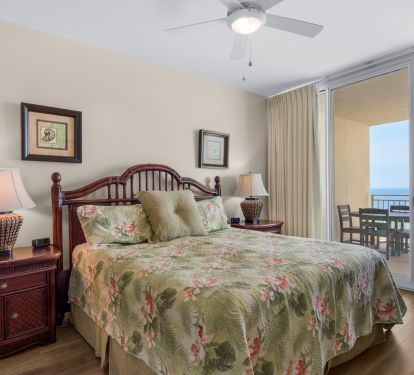 Oceanfront primary bedroom with balcony access.