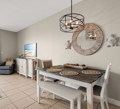 Coastal dining area with ocean views, beach decor, and modern lighting