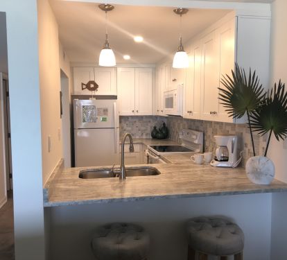 This fully equipped kitchen has beautiful granite countertops. The extended bar with stools is perfect for entertaining.