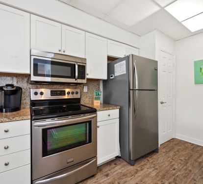 Fully stocked kitchen with stainless steel appliances.
